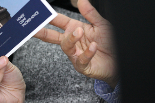 Close-up of hands holding a brochure at Mulgrave Law.